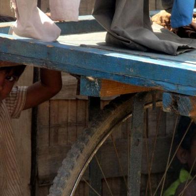 Fourth-grader Mahesh addressed the theme "Those We Respect" by photographing two children who spend their mornings before school pushing their father's tailoring cart as he sleeps at home.