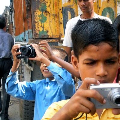 For the theme "Okhla from New Angles," fifth-grader Deepak took this picture of classmates Ashish and Akash, as a curious local resident looked on.