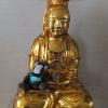 Skids sits on the lap of Guan Yin, the Goddess of Mercy