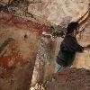 Archaeologist William Saturno of Boston University carefully uncovers art and writings left by the Maya some 1,200 years ago. The art and other symbols on the walls may have been records kept by a scribe, Saturno theorizes. Photo by Tyrone Turner c. National Geographic