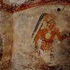 Never-before-seen artwork - the first to be found on walls of a Maya house - adorn the dwelling in the ruined city of Xultun. The figure at left is one of three men on the house's west wall who are painted in black and wear identical costumes. Excavation and preservation of the site were supported by the National Geographic Society.  Photo by Tyrone Turner c. 2012 National Geographic