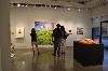 Gallery visitors looking at Lopez? Love Like a Sunset, Oil on canvas.