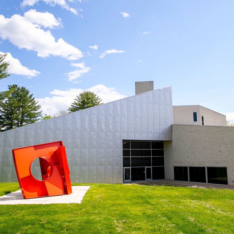 Exterior view of the Tang Teaching Museum on Skidmore’s campus, with a bold red sculpture in front.