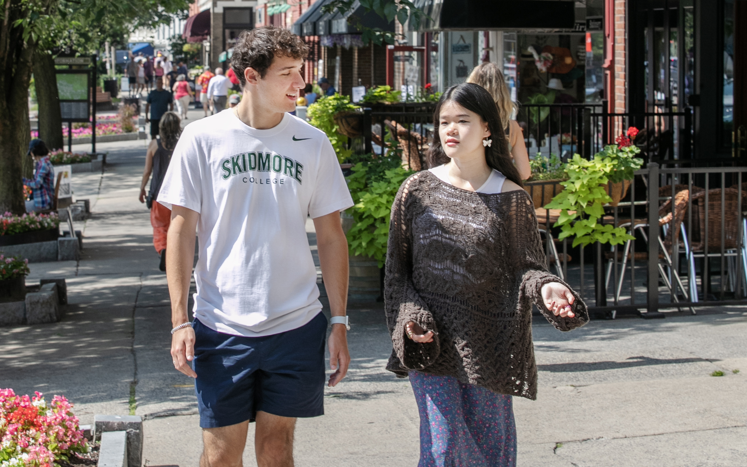 Two students walk down Broadway.