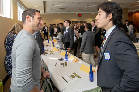College student and an employer meet at a career fair