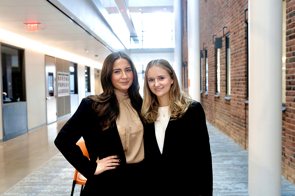 two students in professional suits