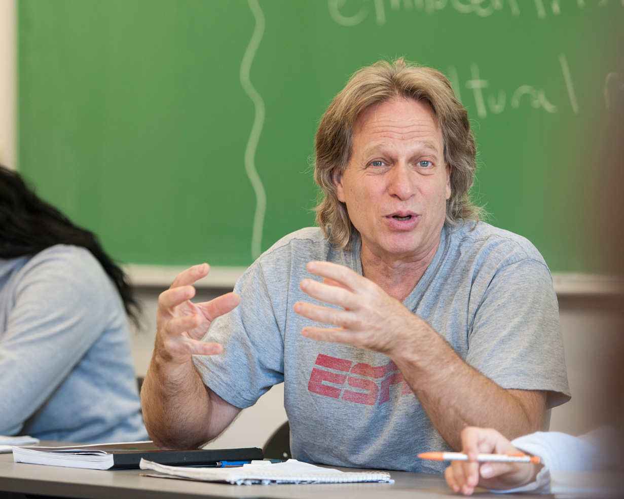professor in class talking to his students