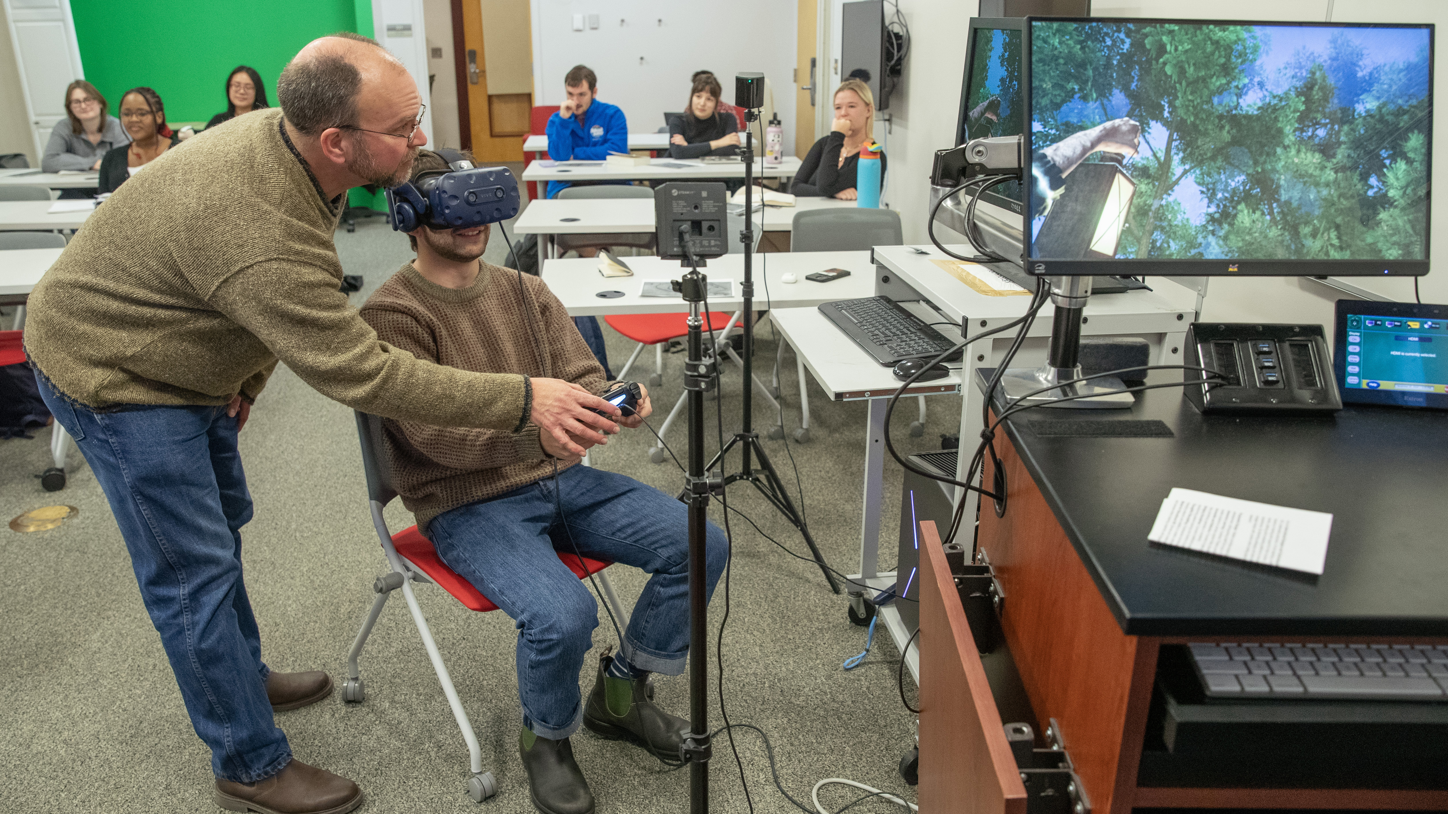 Ben Harwood assists a student as they navigate "Walden, a Game."