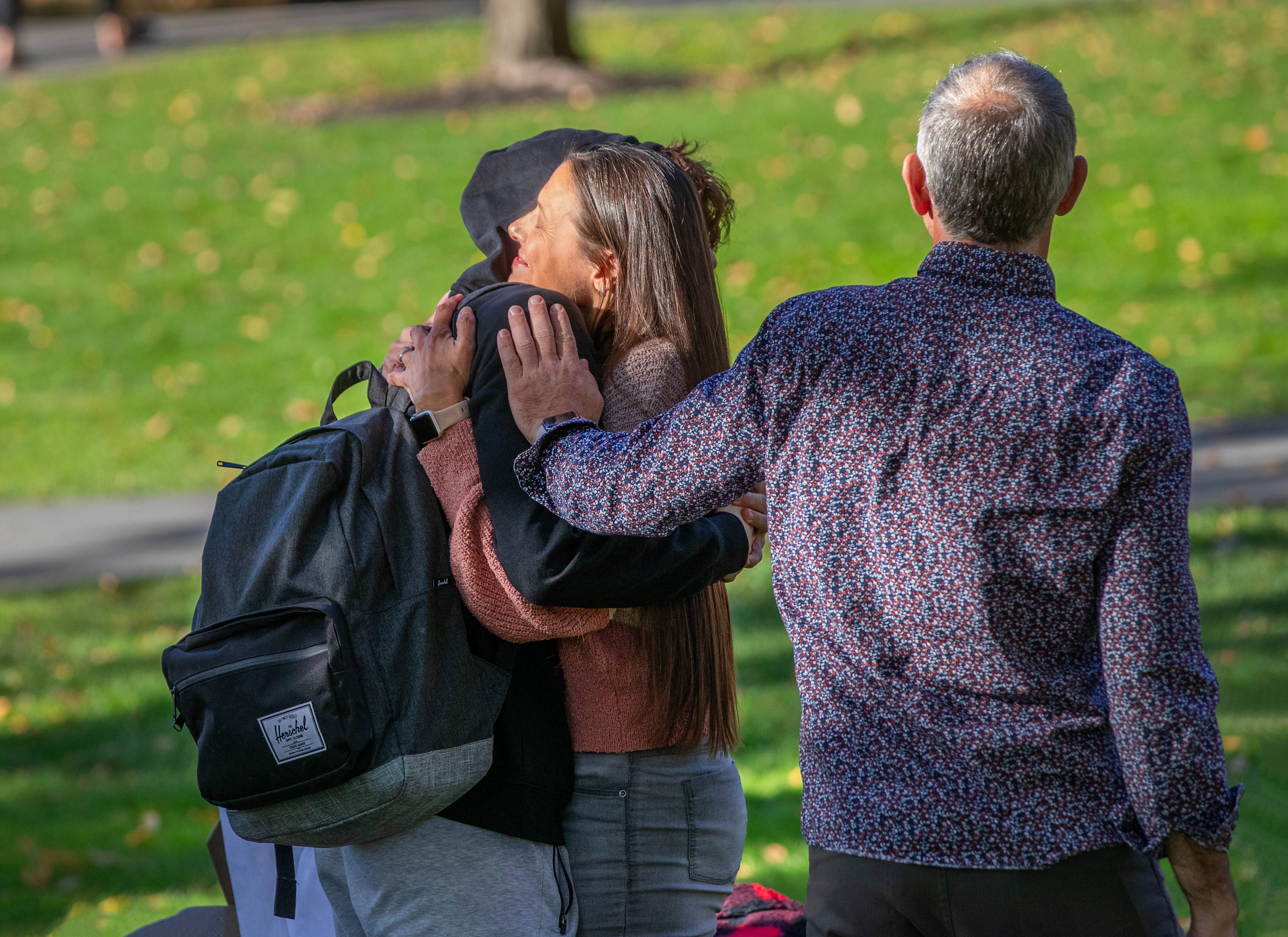A parent embracing a student on campus during Skidmore's homecoming weekend.