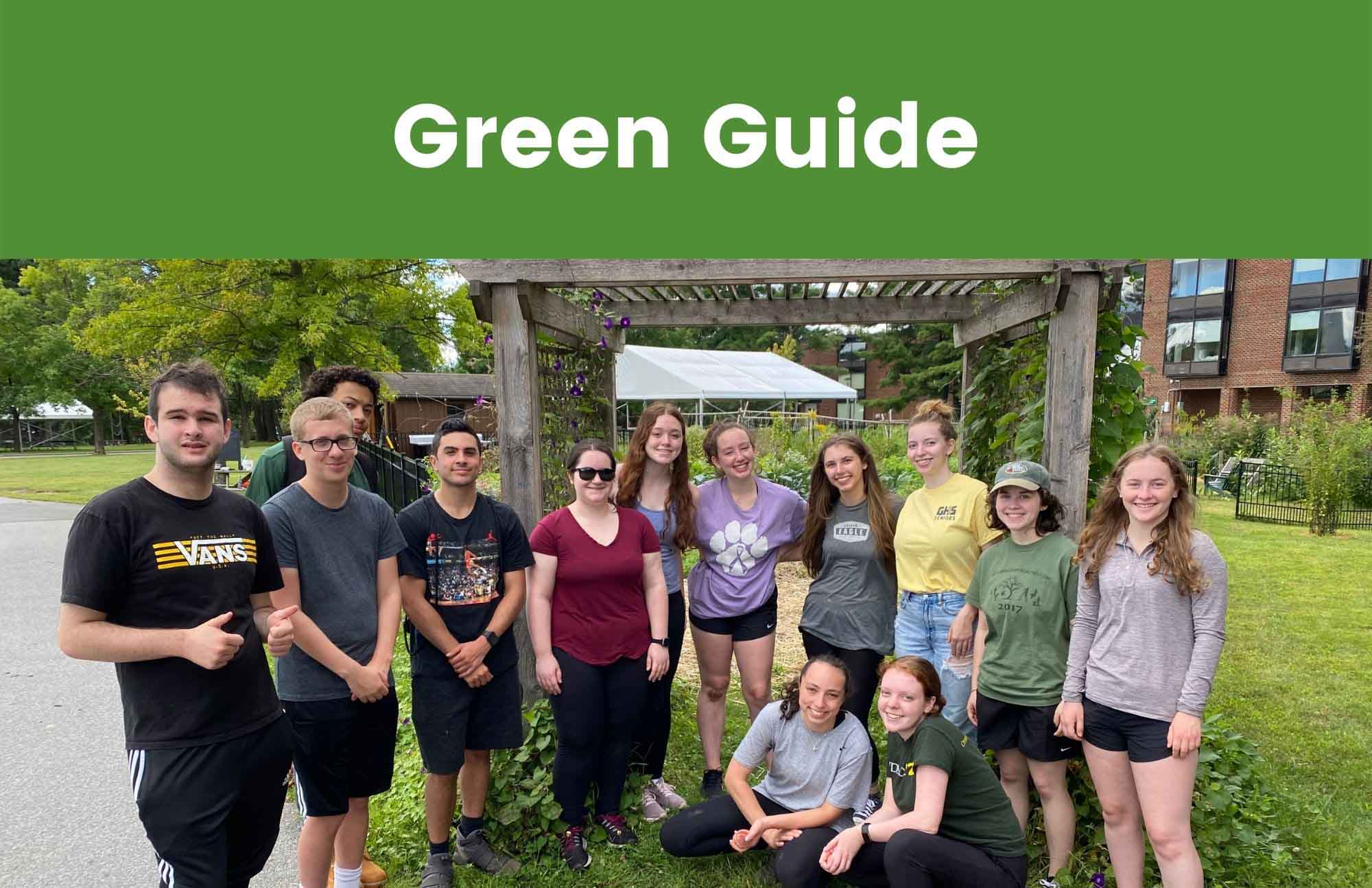 A group of students stand together in front of the garden after an orientation event