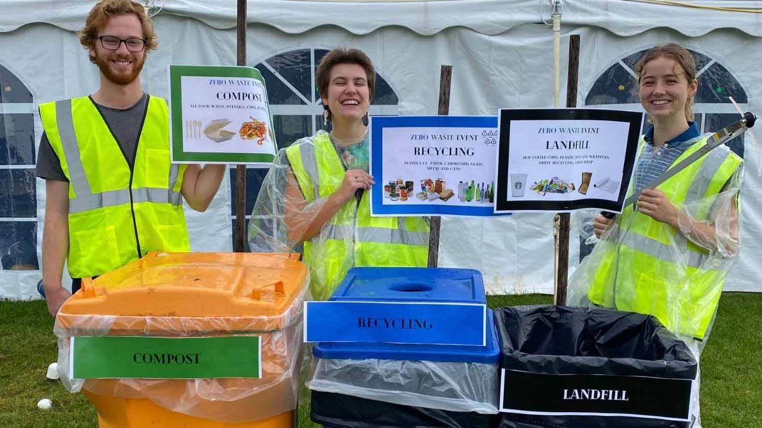 picture of three students standing by colorful bins