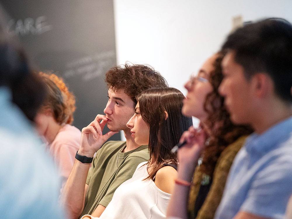 Students listen intently during an election program at the Tang Teaching Museum