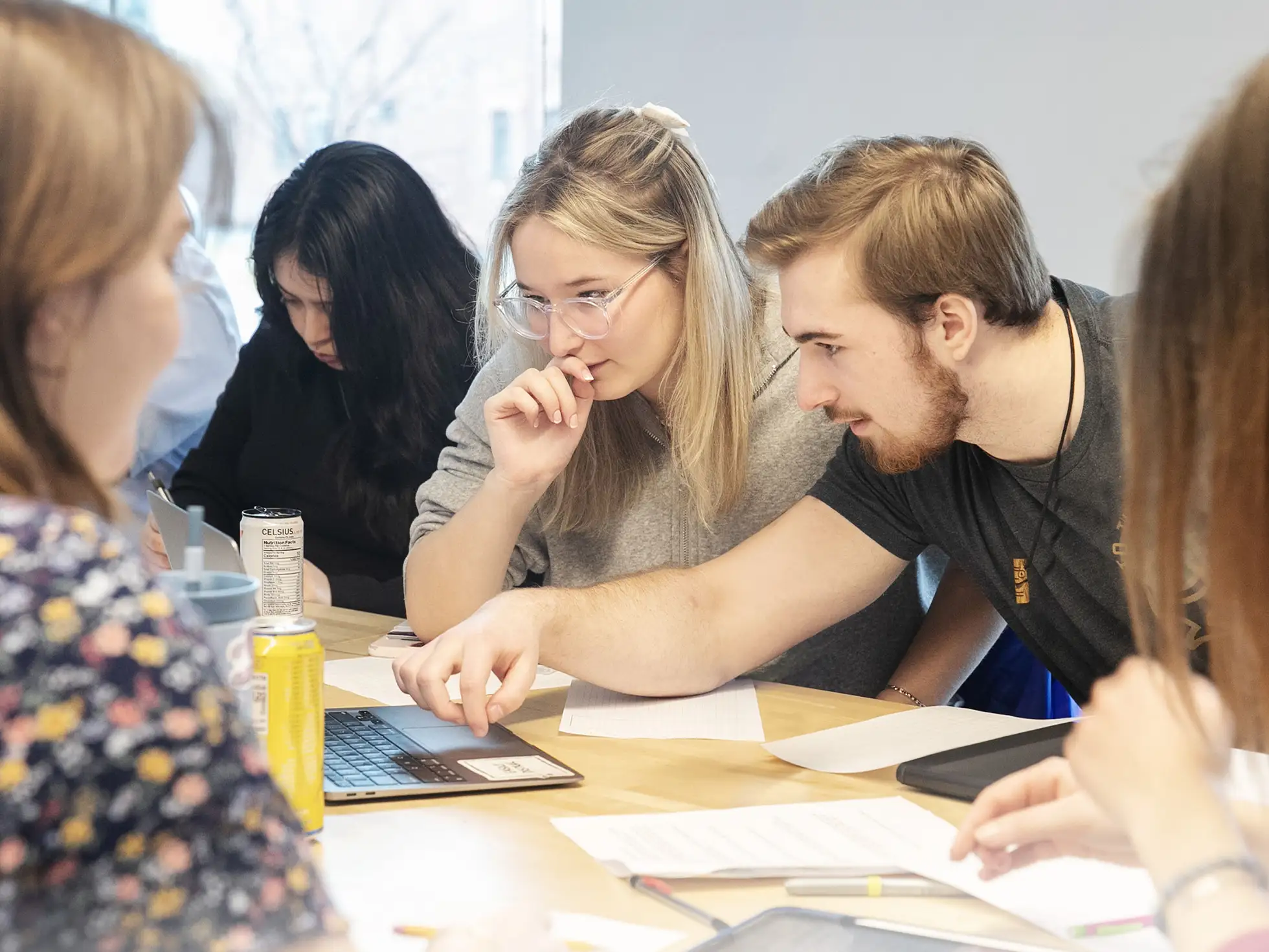 Students in a Classics course collaborate on laptops to build a historically inspired Roman town in Minecraft, applying creative thinking and digital tools to bring ancient history to life.