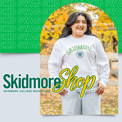 Student standing outdoors in front of autumn foliage wearing a gray Skidmore sweatshirt, with promotional text reading “Skid Swag” and “Skidmore Shop – Skidmore College Bookstore.”