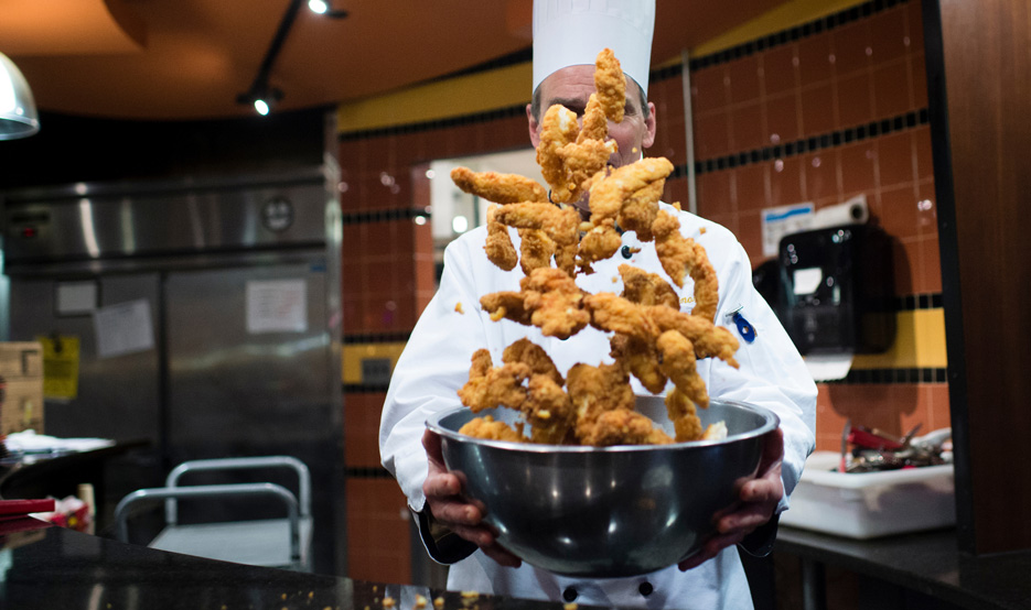 Chicken Fingers being tossed in the air