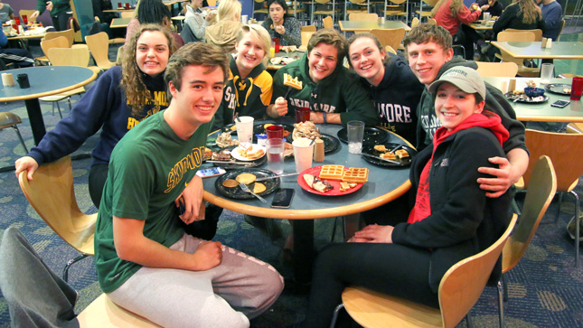 Skidmore students eating waffles in the dining hall