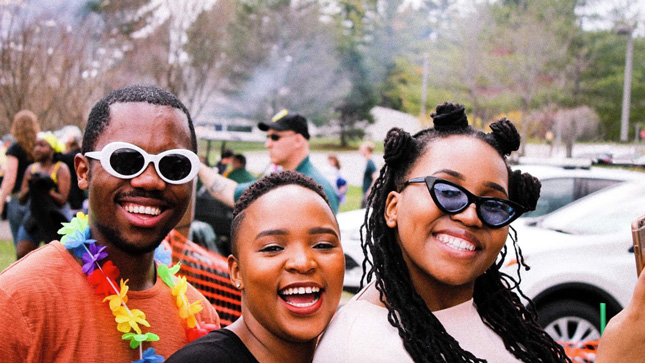 Three students at a festival at Skidmore College