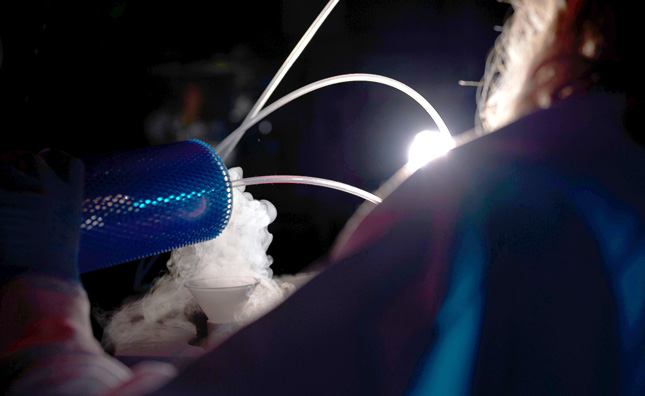 A college student works with liquid nitrogen in a chemistry lab