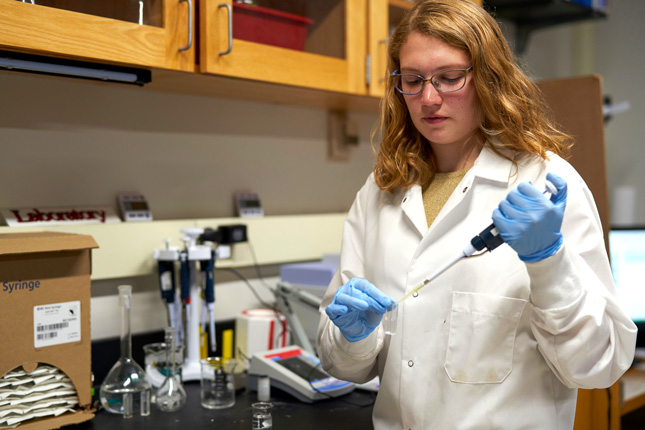 Heather Ricker, a Skidmore College student, drops nitrogen in a test tube in a chemistry lab