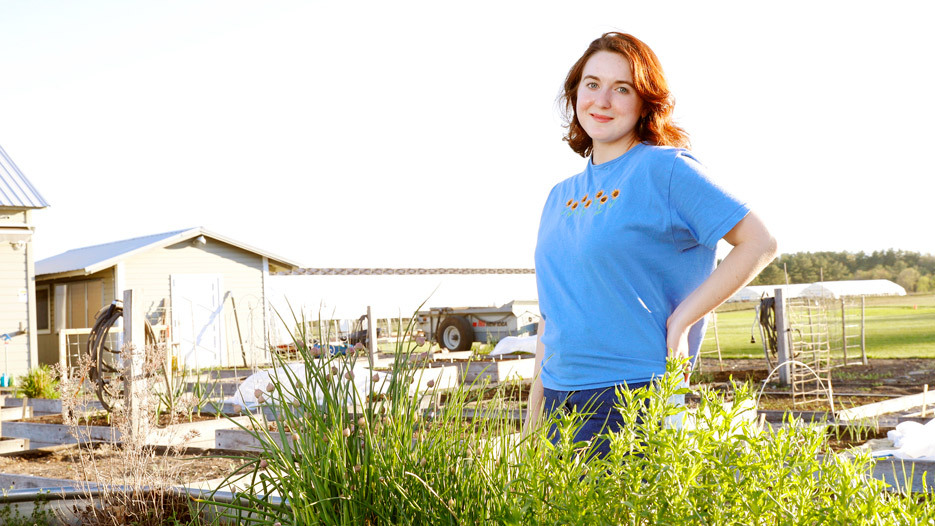 young woman standing in farm field