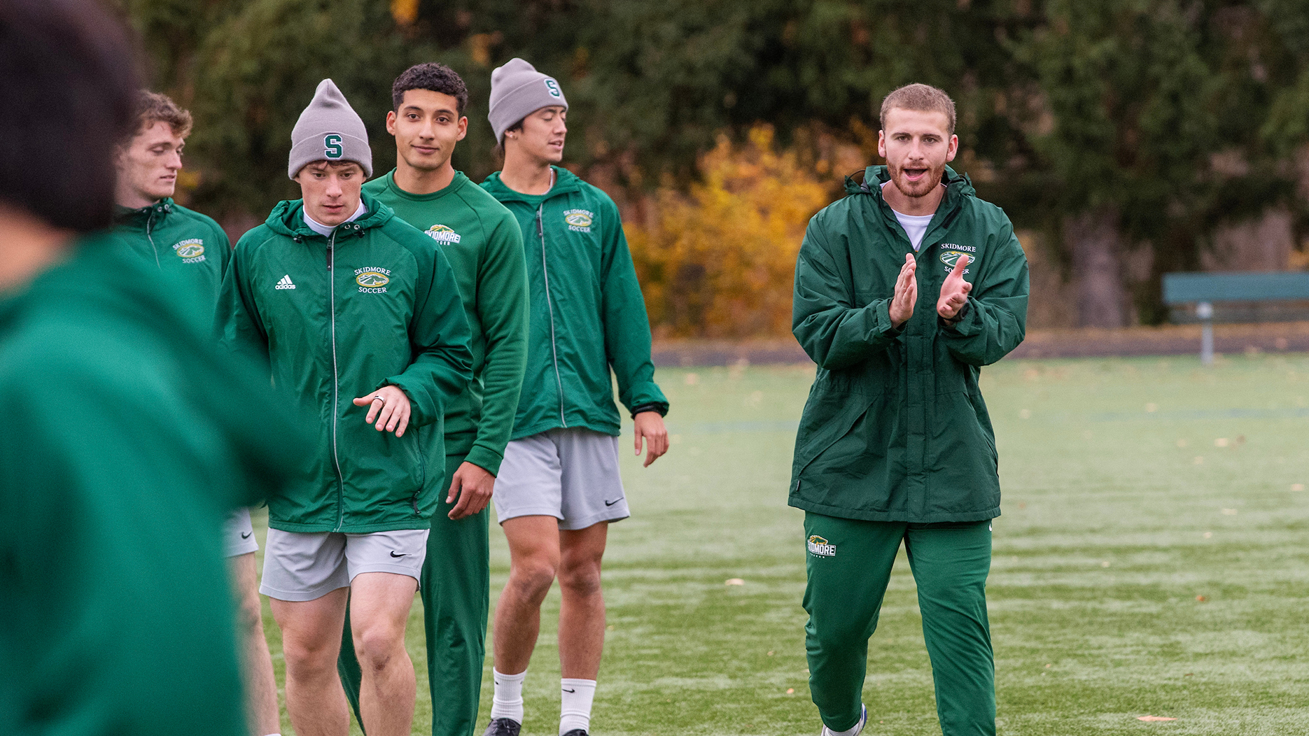 Owen Brady '25 cheering on Skidmore men's soccer players at practice.