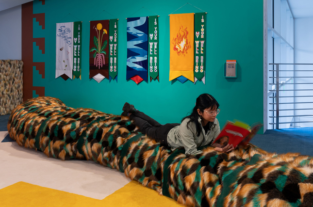 Chiara Garcia-Ugarte ’25 interacts with artist Yvette Molina's exhibition "A Promise to the Leaves" on the Tang mezzanine.