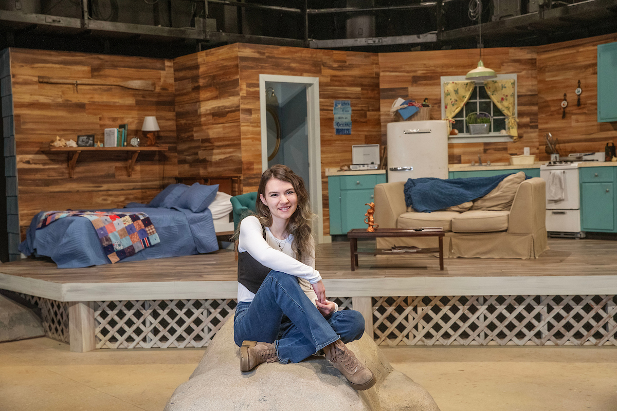Adelaide Lance ’25 on the stage she designed for the “Last Summer at Bluefish Cove.”