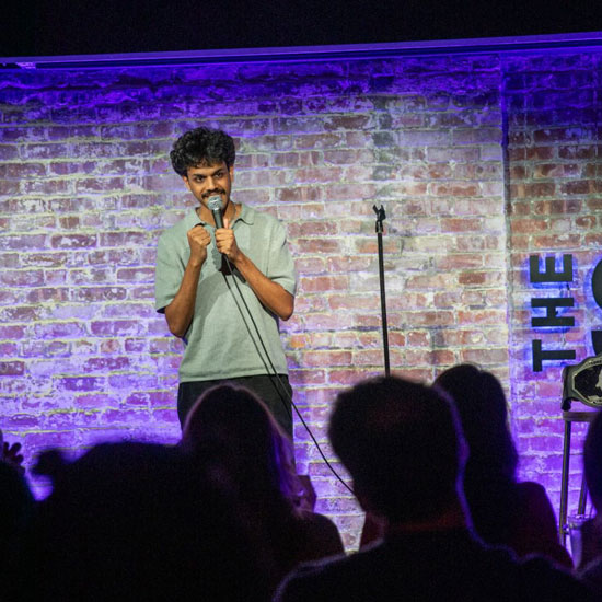 Student+Kartik+Vaish+performs+stand-up+comedy+show+on+a+stage+to+an+audience.