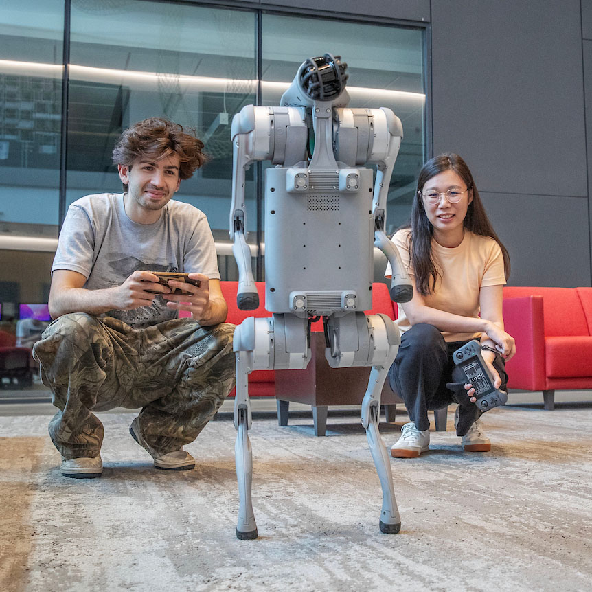 Hamza+Mustafa+%E2%80%9927+and+Assistant+Professor+of+Computer+Science+Wenlu+Du+with+the+robotic+dog+they+trained+to+walk+over+the+summer.+