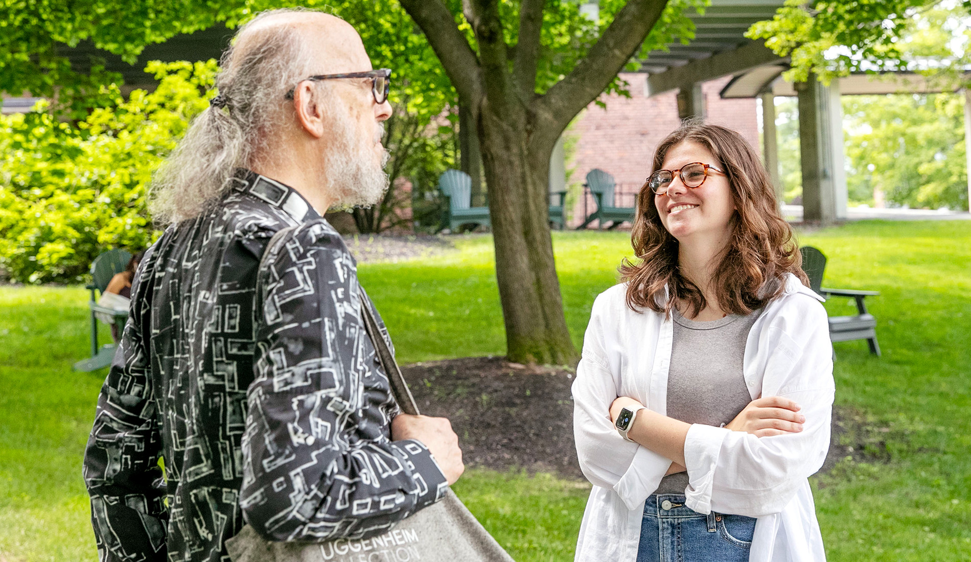 Charlotte Mahn '25 and Professor of English Robert Boyers on the Skidmore green.