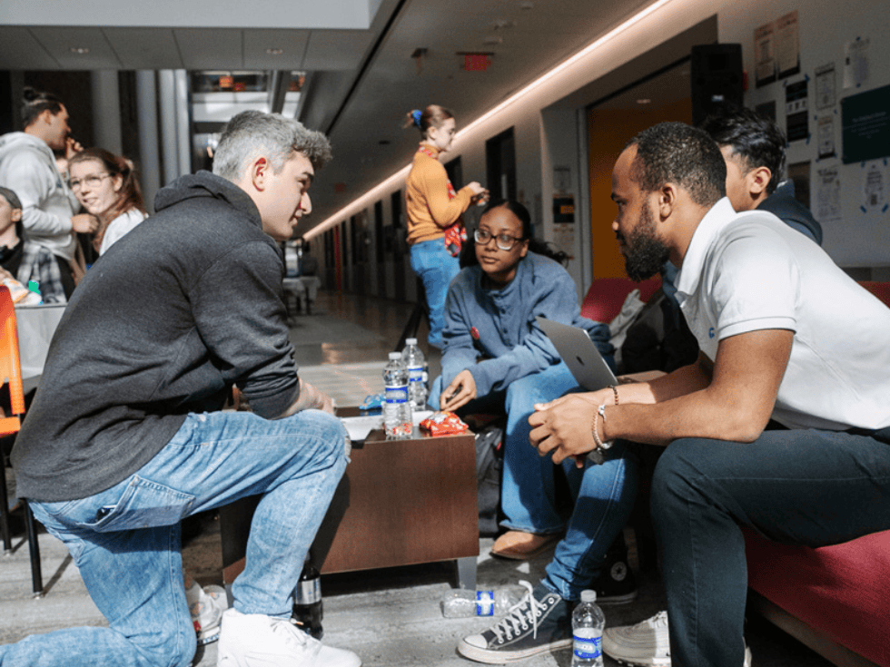 Students discussing a project in the Atrium of Billie Tisch Center for Integrated Sciences during StartUp Skidmore