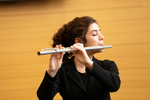 female college student plays the flute