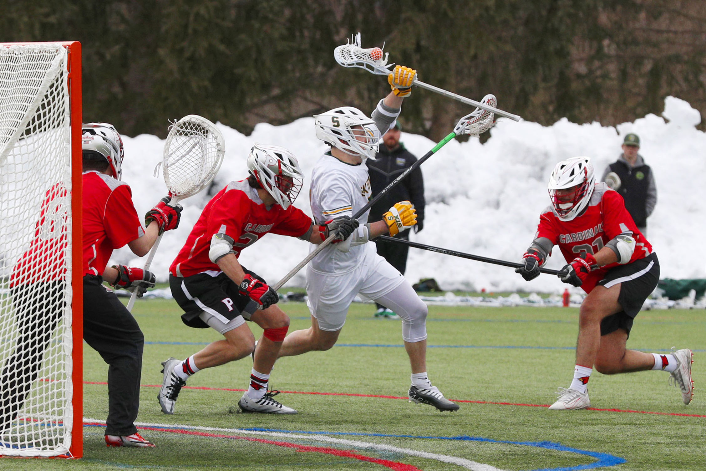 a scene of multiple men's lacrosse players in action during a game