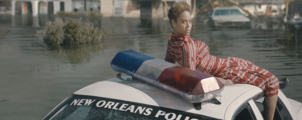 Black woman on a NO police car in a flood