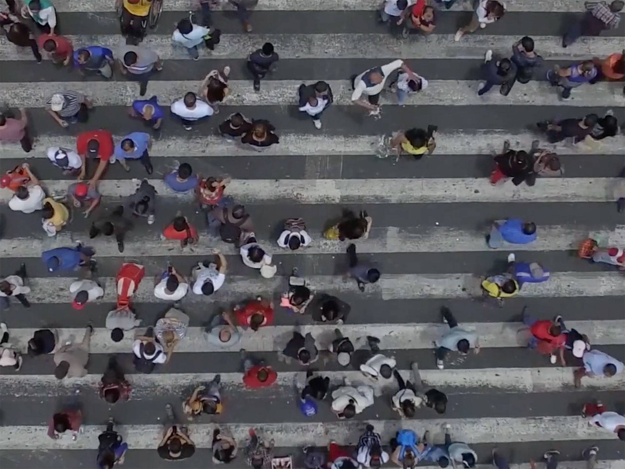 Still shot of people crossing the street from ariel view