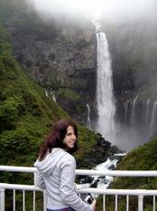 Devin Sugameli '08 standing in front of waterfalls at Nikko
