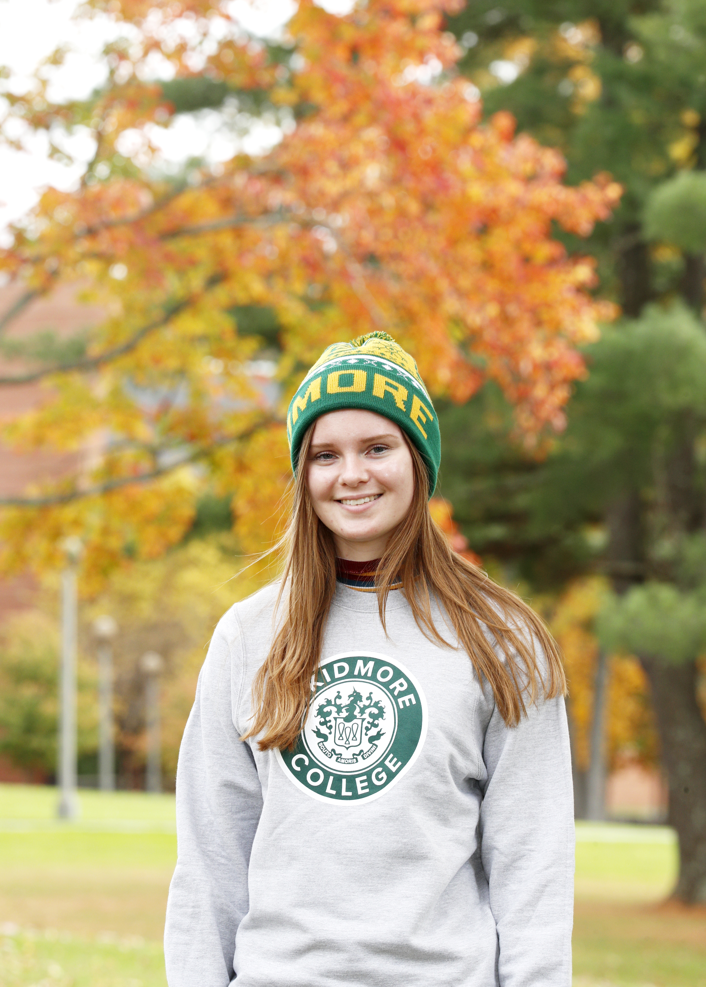 Photo of Caroline Forte wearing the cozy pom-pom hat and the crewneck sweatshirt