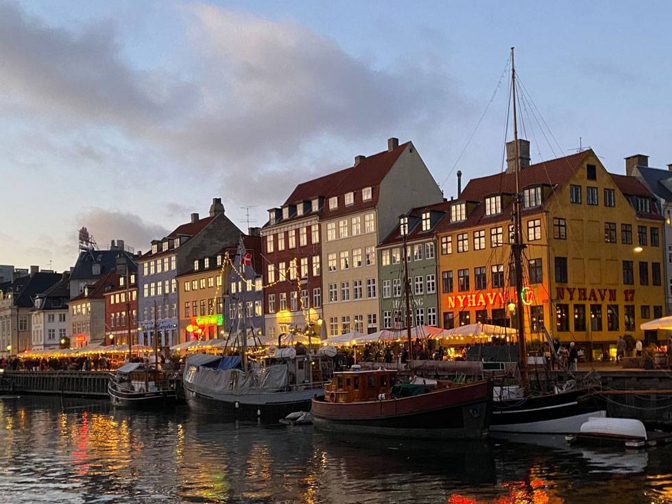 Row buildings of different colors, situated on a river in Denmark