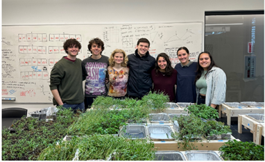 Students next to some plants