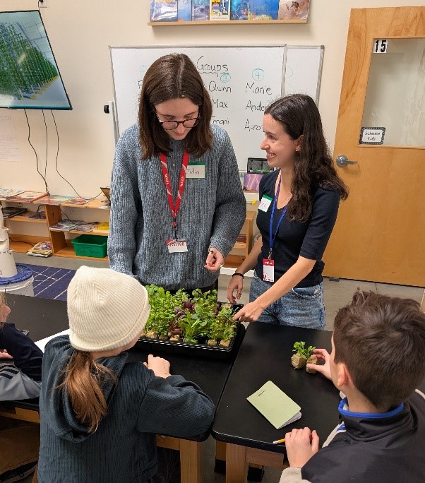 Students examining some plants in the classroom