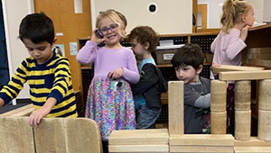 Kids playing with wooden building blocks