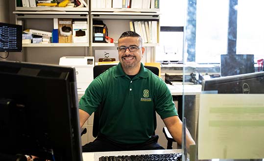 Campus safety officer sitting at his desk