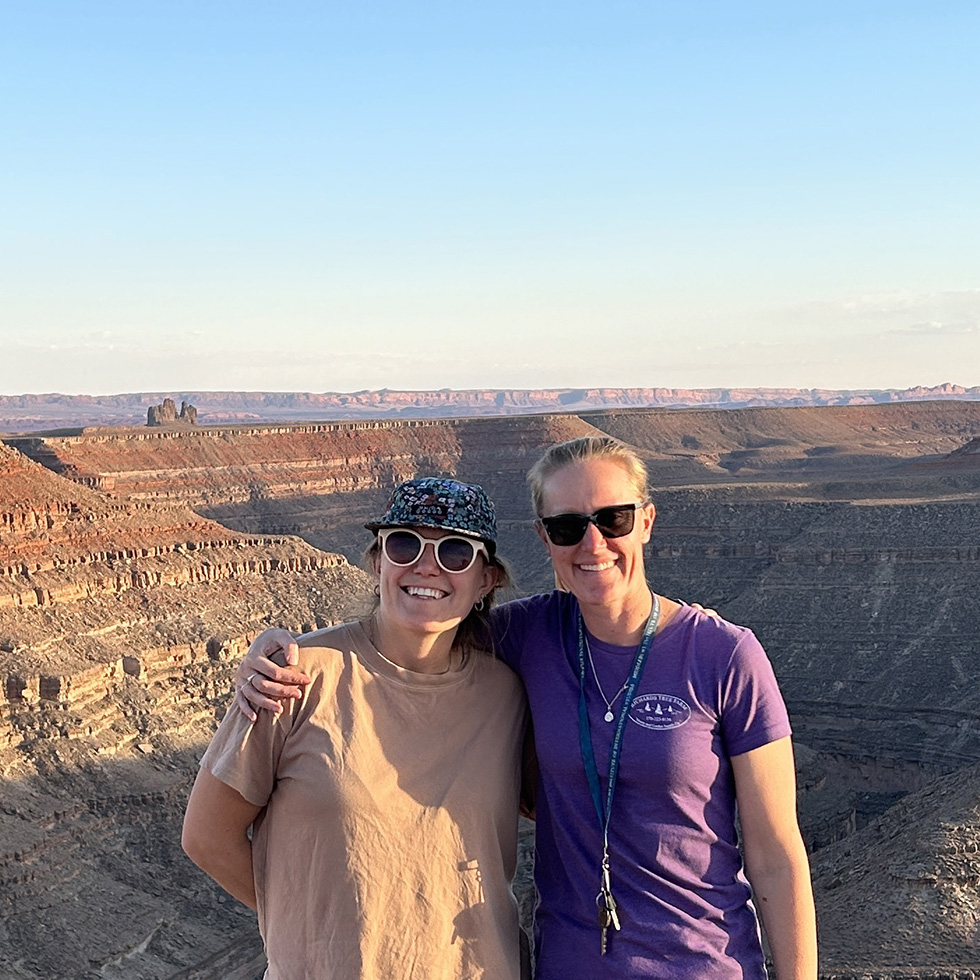 Anna Graves and Danika Robison stand in front of a canyon.