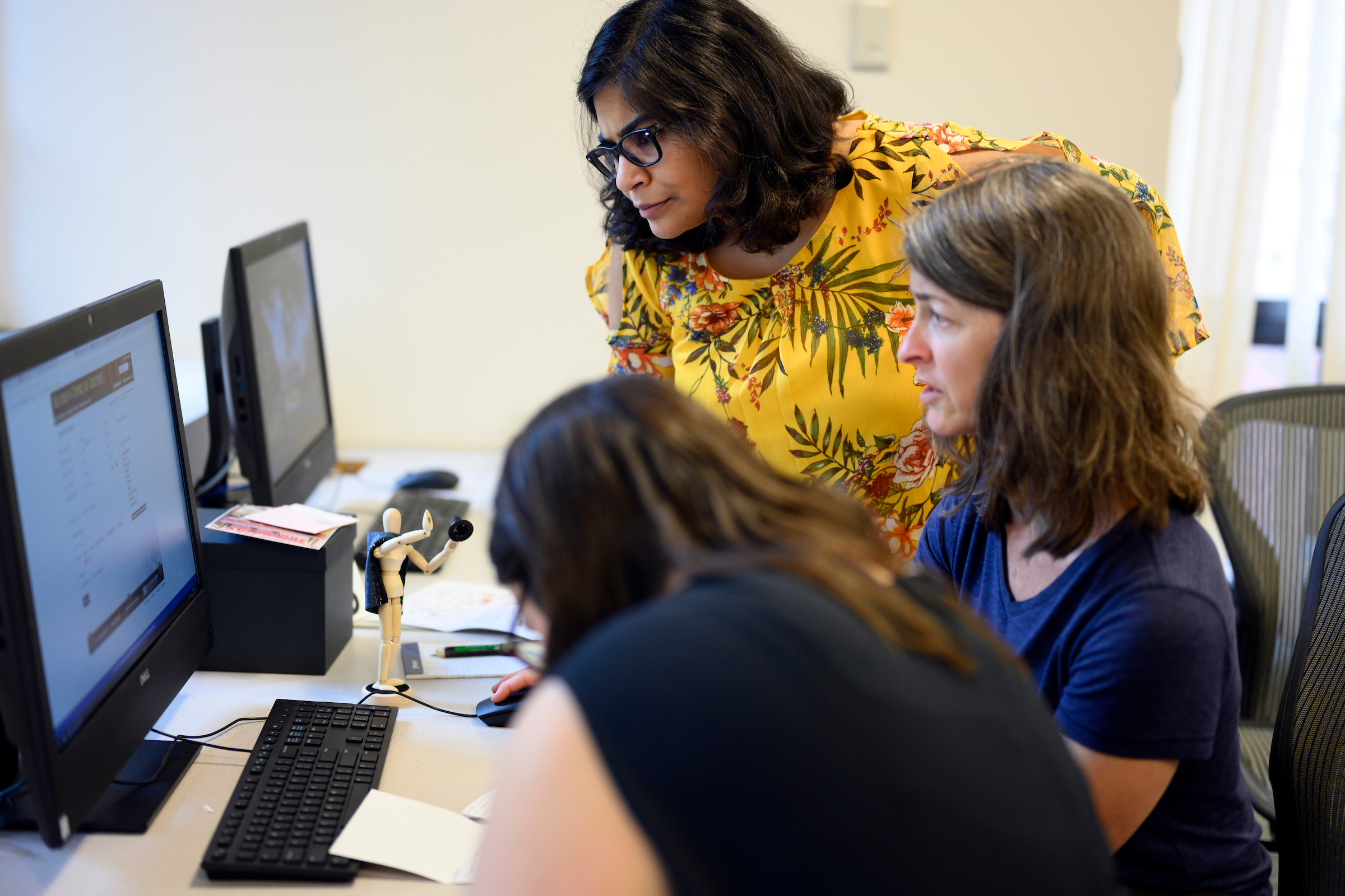 Faculty and staff volunteers test a game for new students