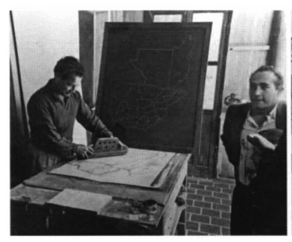 Julio Piedra Santa and staff member working on a map of Guatemala