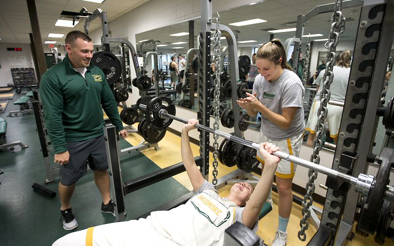 Matt Chatham oversees as two-time All-American Kelly Donnelly '18 works on bench presses, with Haley English '19 spotting.