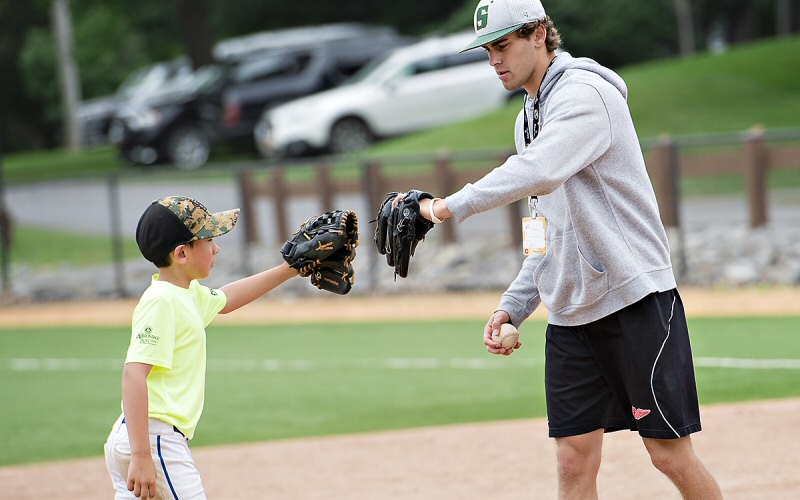 Also a T'bred hockey player, Tim Allen '20 role-models some team spirit; this is his first summer of helping teach Skidmore's baseball clinic.