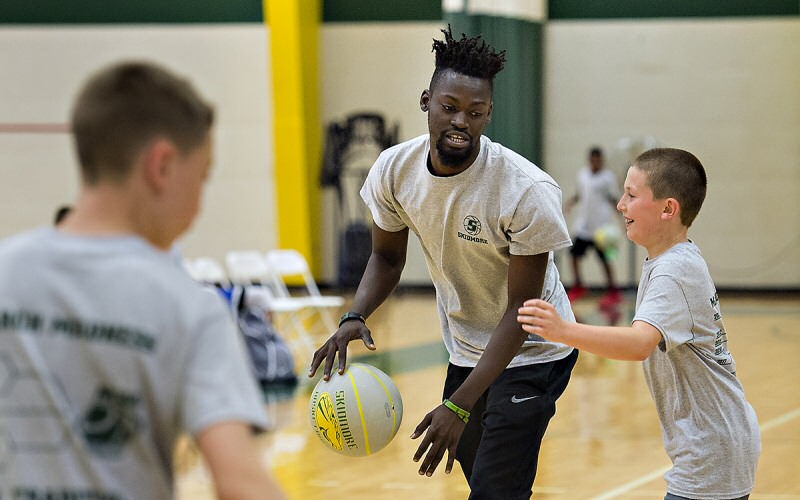 Deepee Yiljep '19 teaches some rebounding and ball-handling skills.