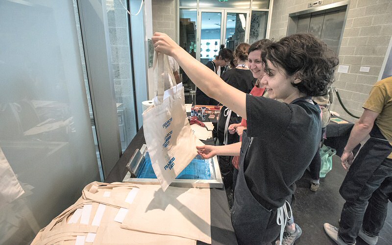 Printing tote bags is just one of the guided do-it-yourself experiences during Frances Day.