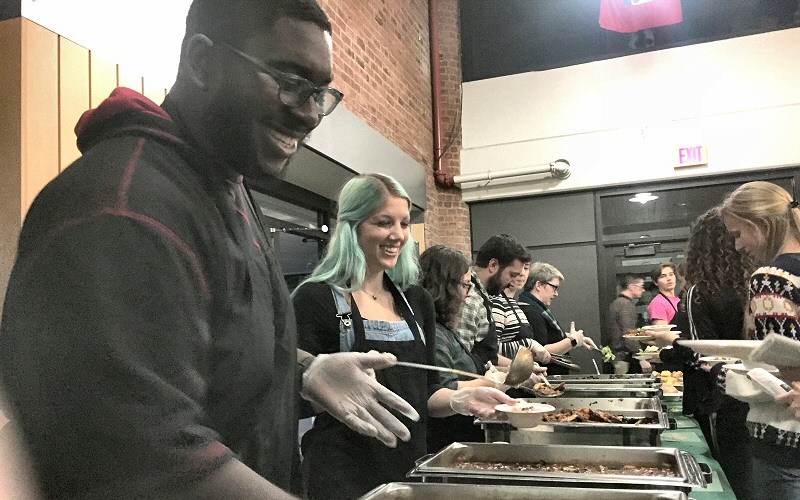 Volunteers dish up vegetarian chili and cornbread, salad, roasted root vegetables, braised greens and apple crisp.